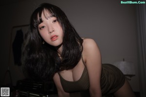 A woman in a brown dress posing for a picture.