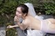 A woman in a wedding dress laying on the ground.