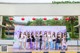 A group of women standing in front of a sign that says Sun Nature Flowers and Hot Spring Towns.