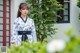 A woman wearing a blue and white kimono standing in front of a building.